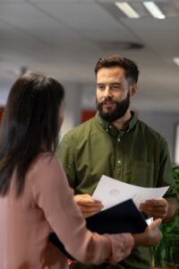 Leader listening empathetically during a workplace conversation, illustrating emotional intelligence and emotional labour in leadership
